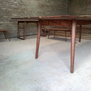 Tables with tapered legs out of dark timber