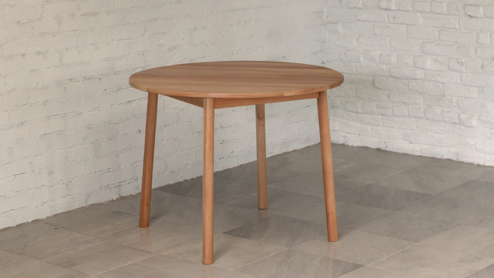 Eucalyptus grandis wooden round table with gently splayed round section legs