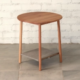 Wooden side table round section legs round top blueish grey fabric shelf