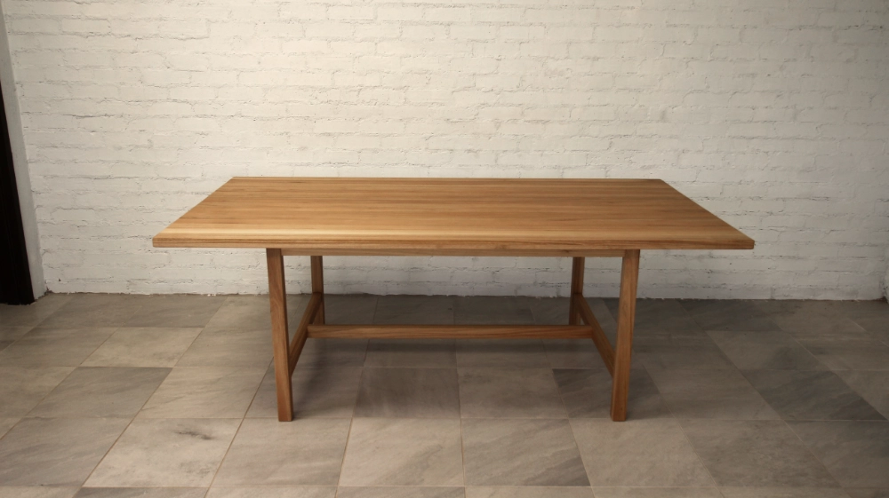 Eucalyptus Cloeziana wooden table, vertical square section legs with lower rails and cross member.