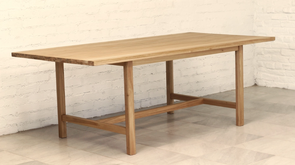 Eucalyptus Cloeziana wooden table, vertical square section legs with lower rails and cross member.