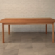 Wooden table with gently splayed round section legs 6 seat.