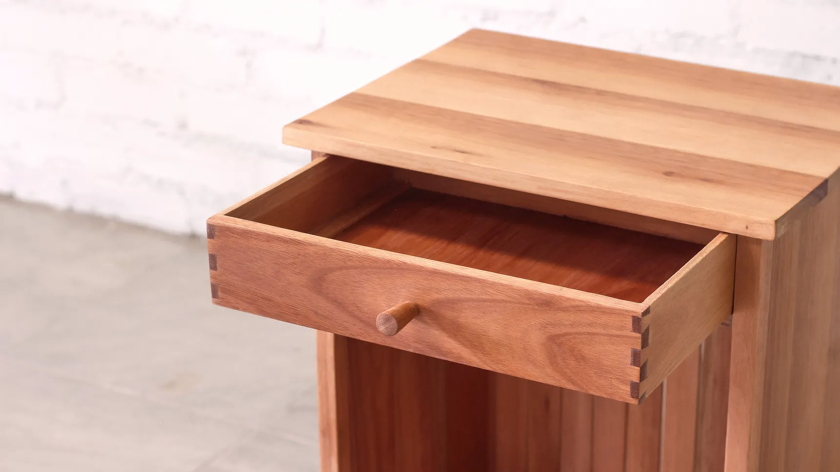 Bedside table open drawer detail, exposed joinery