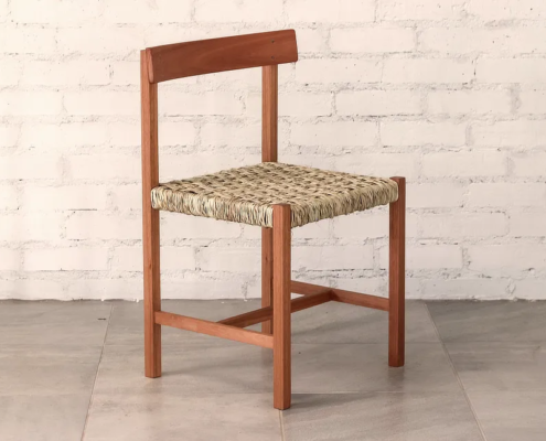 Chair made from deep brown timber, natural woven ilala palm seat and curved backrest.