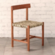 Chair made from deep brown timber, natural woven ilala palm seat and curved backrest.