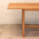 Detail of table with linear aesthetic made from pale timber.