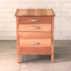 Front view of drawer set made from warm, pale brown timber,