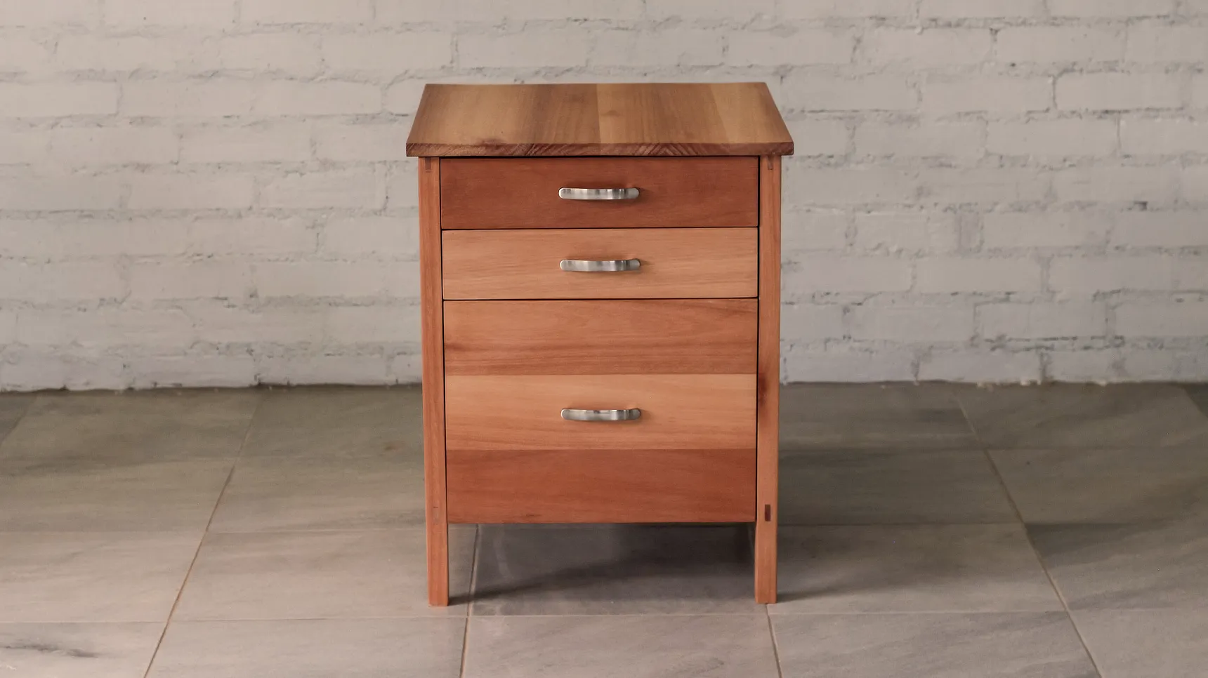 Front view of set of drawers made from pale timber brown timber.
