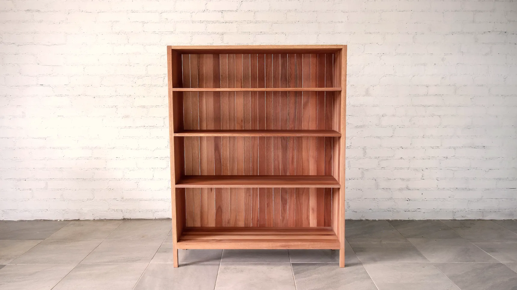 Shelving Front Bookcase made from deep brown timber showing shelves and slatted hardwood back panel.